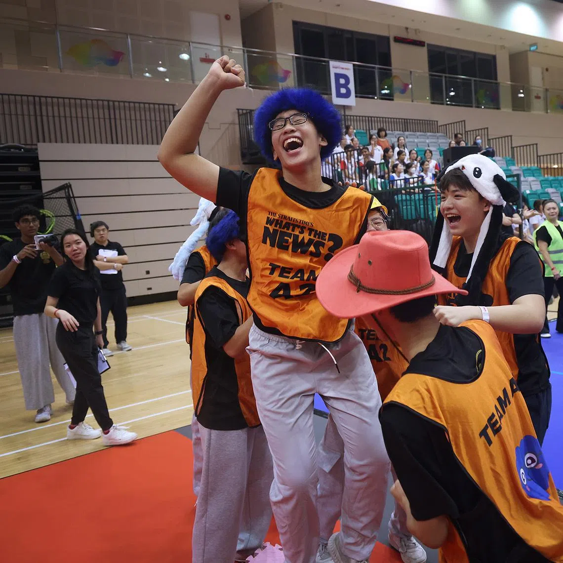 ST20260514_202634800297/jrcurtain12/Jason Quah (SUGGESTED MAIN PIC #1) St. Gabriel's Secondary School students Pierson Png, 15, (left) and Kaeden Tan, 16, celebrate with their teammates after crossing the finish line in Final Stretch during the semi-finals of current affairs competition What's The News? At Our Tampines Hub on May 14, 2026. They were the only team to successfully cross the finish line in its entirety. ST PHOTO: JASON QUAH