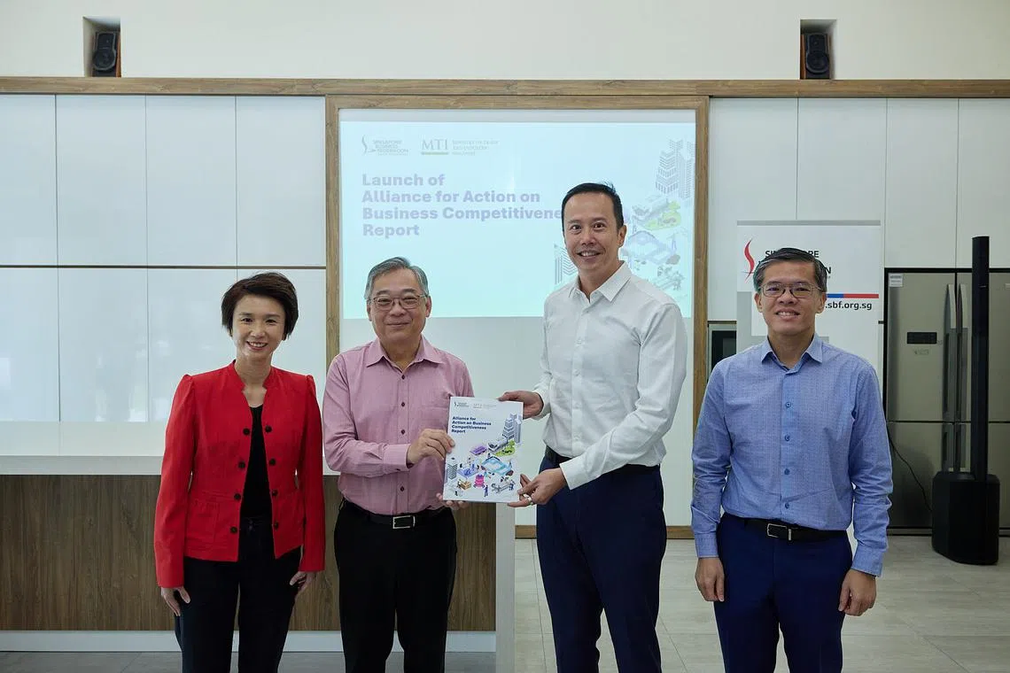 DPM Gan Kim Yong receiving the AfA on Business Competitiveness report from AfA co-chairs Mark Lee (right) and Senior Minister of State Low Yen Ling (far left), together with SBF CEO Kok Ping Soon (far right).