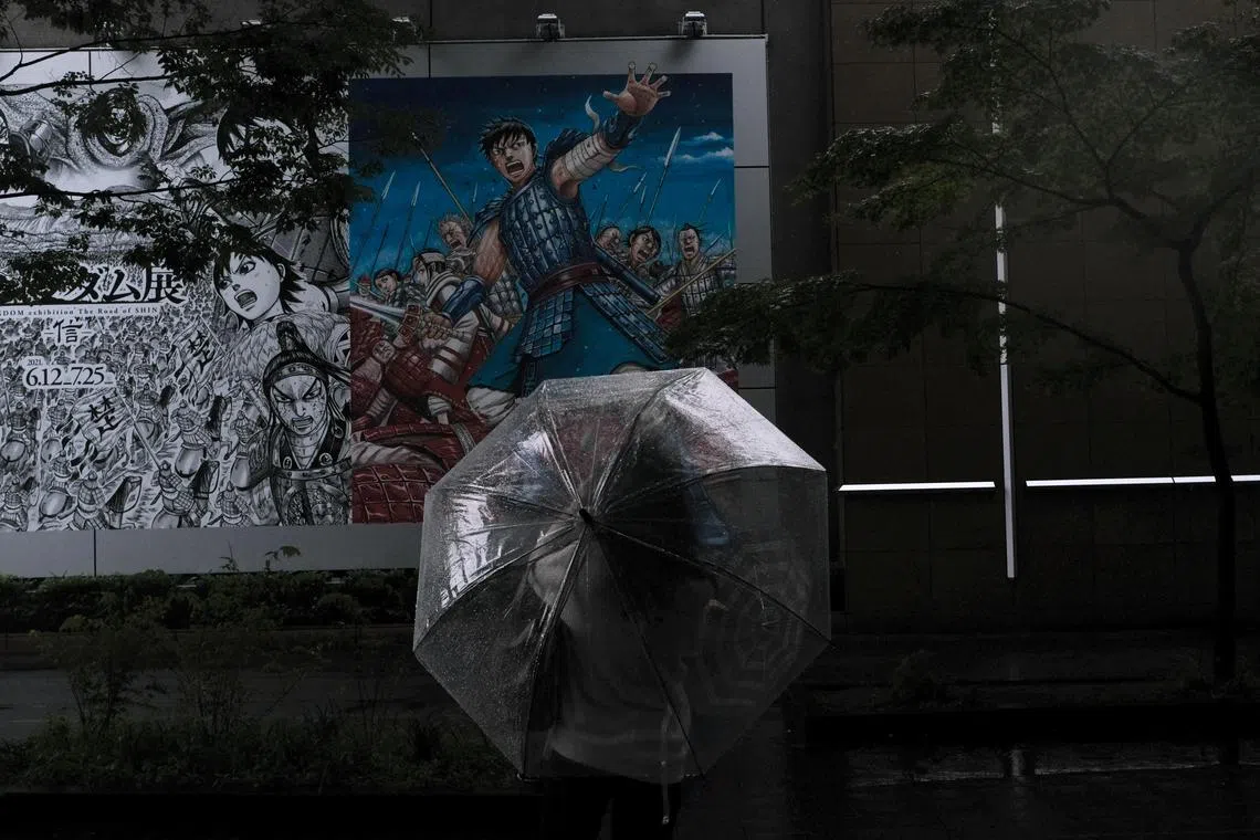 A visitor looks at the posters advertising an exhibition on the Japanese manga series Kingdom at the Ueno Royal Museum in Tokyo in 2021. The manga has sold roughly 110 million copies in Japan, making it one of the top 20 best-selling series of all time.