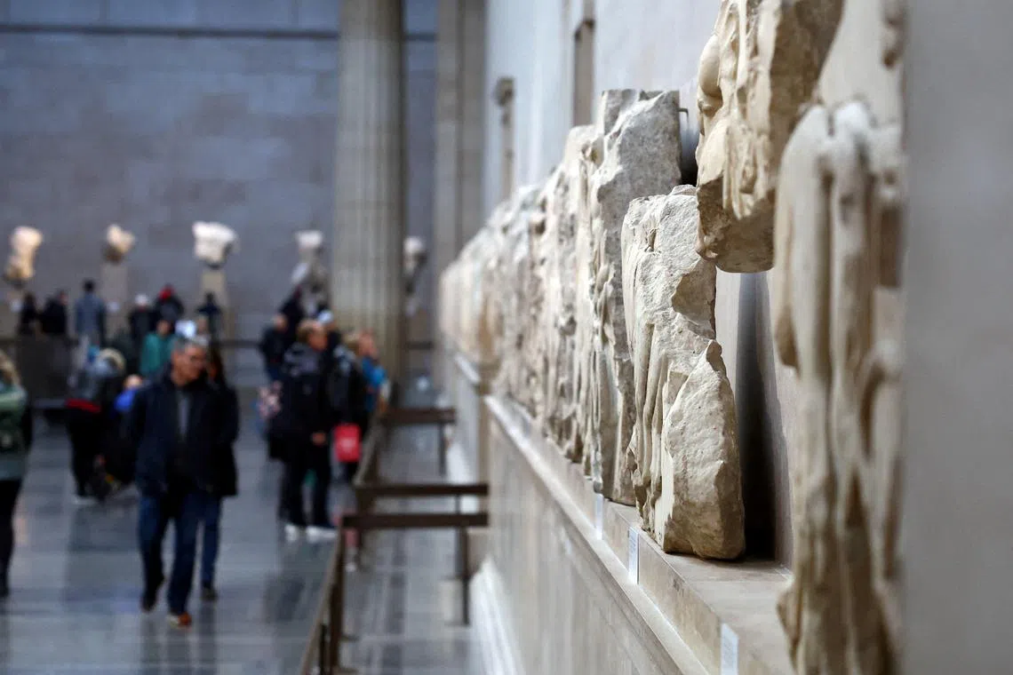 FILE PHOTO: People view examples of the Parthenon sculptures, sometimes referred to in the UK as the Elgin Marbles, on display at the British Museum in London, Britain, November 29, 2023. REUTERS/Hannah McKay/File Photo