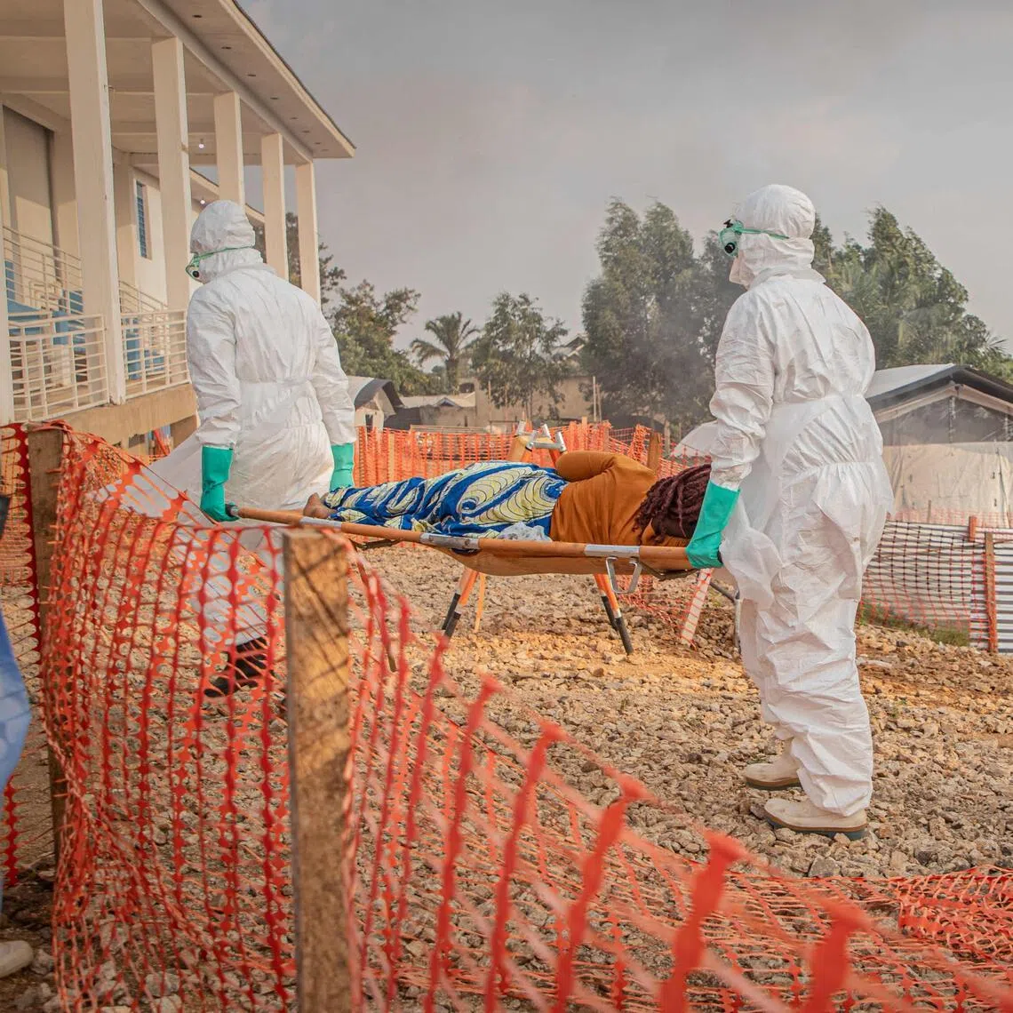Healthcare workers carry on a stretcher a patient suffering from the Ebola virus disease from an ambulance at the Ebola Treatment Center (ETC) in Bunia, Ituri, in the east of the Democratic Republic of Congo on June 23, 2026. (Photo by Benediction MURHABAZI / AFP)