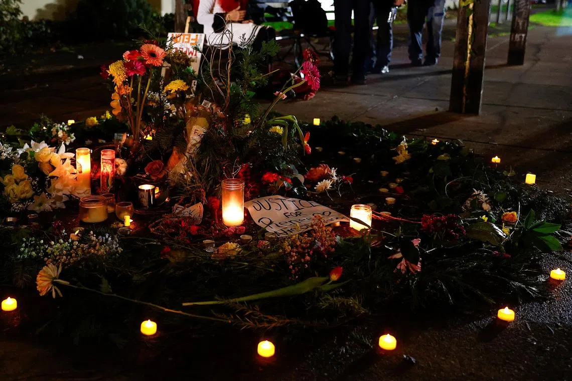 Flowers and candles are placed outside the Portland ICE facility during a vigil, after U.S. federal agents shot two people in Portland, Oregon, U.S., January 9, 2026.  REUTERS/John Rudoff