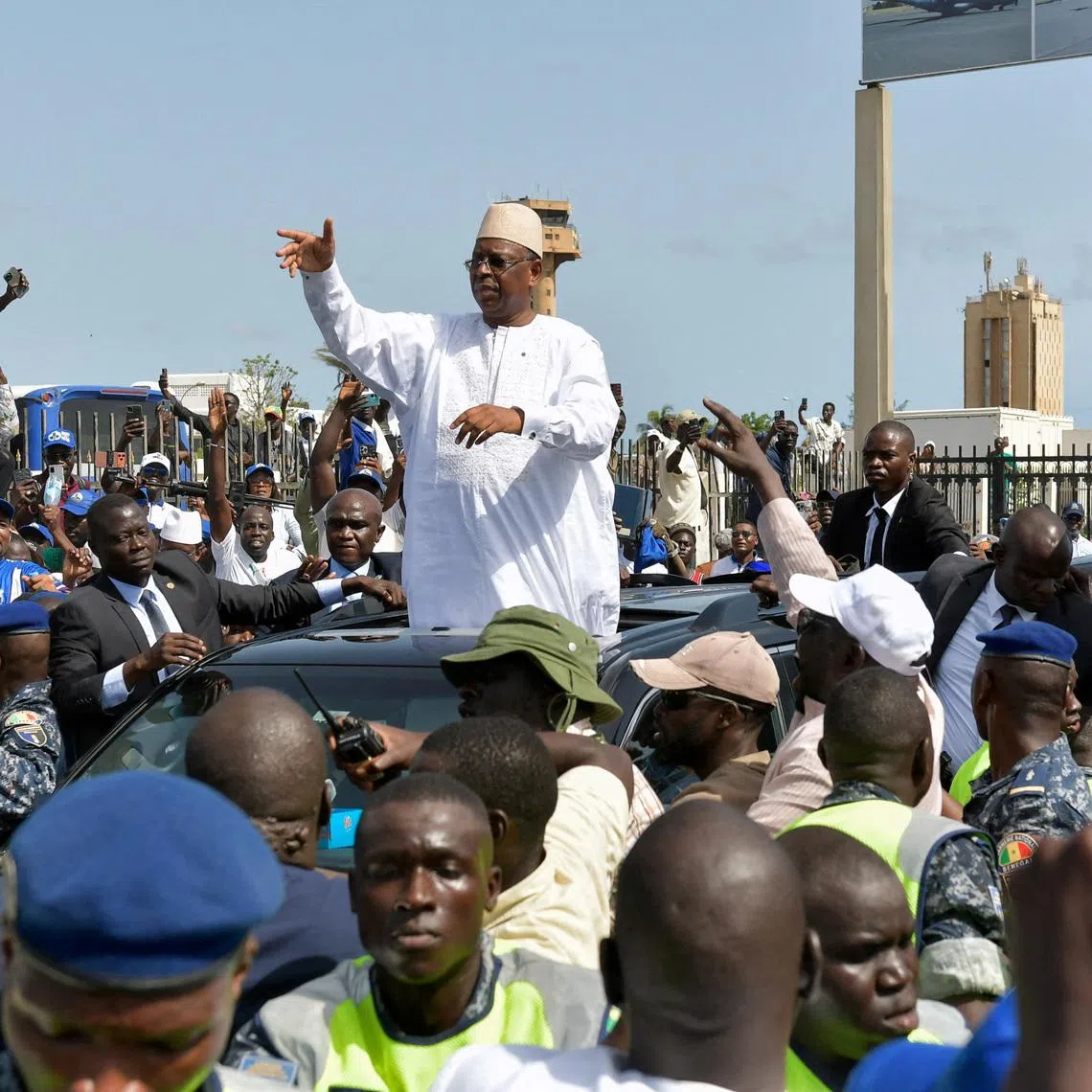 Former Senegalese President Macky Sall gestures to supporters after returning to Senegal to meet with his successor, President Bassirou Diomaye Faye, as part of Sall's campaign for the post of United Nations secretary-general, in Dakar, Senegal, July 17, 2026. REUTERS/Alioune Seye     TPX IMAGES OF THE DAY