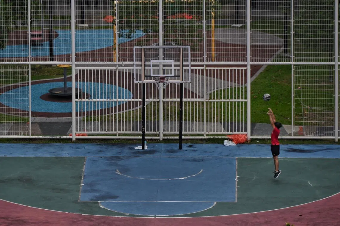 ST20211102_202112064811 Kua Chee Siong/ pixgeneric/ Generic pix of a boy playing basketball alone in a basketball court in Ang Mo Kio Avenue 10 on 2 Nov 2021.