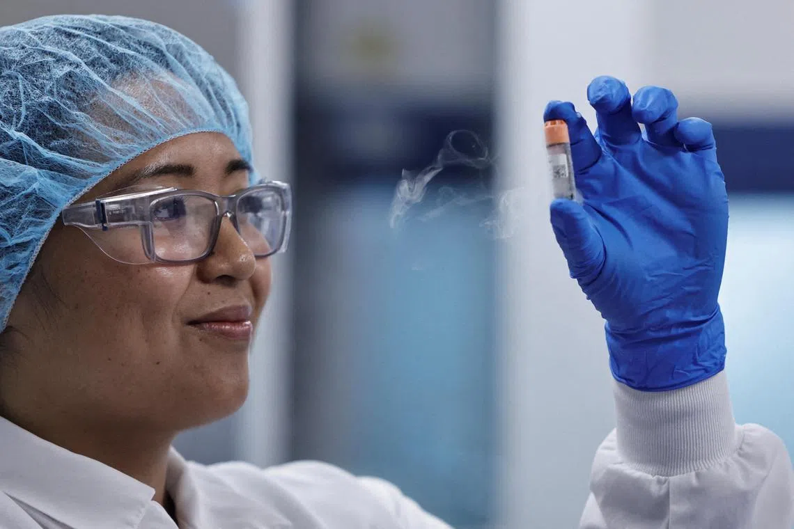 A lab employee with a vial of frozen chicken cells in the seed lab at the Upside Foods plant in California.