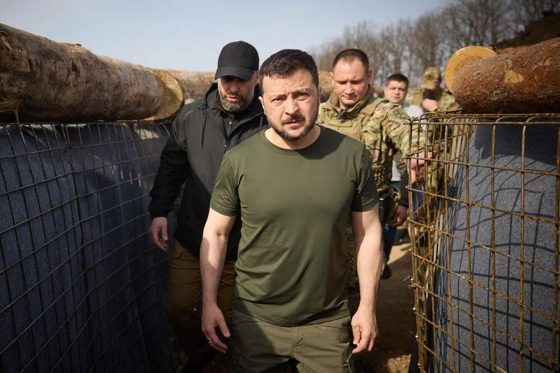 This handout photograph taken and released by Ukrainian Presidential Press Service on April 9, 2024, shows Ukraine's President Volodymyr Zelensky visiting the construction site of a defence line in Kharkiv region, amid the Russian invasion of Ukraine.. (Photo by Handout / UKRAINIAN PRESIDENTIAL PRESS SERVICE / AFP) / RESTRICTED TO EDITORIAL USE - MANDATORY CREDIT "AFP PHOTO / UKRAINIAN PRESIDENTIAL PRESS SERVICE" - NO MARKETING NO ADVERTISING CAMPAIGNS - DISTRIBUTED AS A SERVICE TO CLIENTS