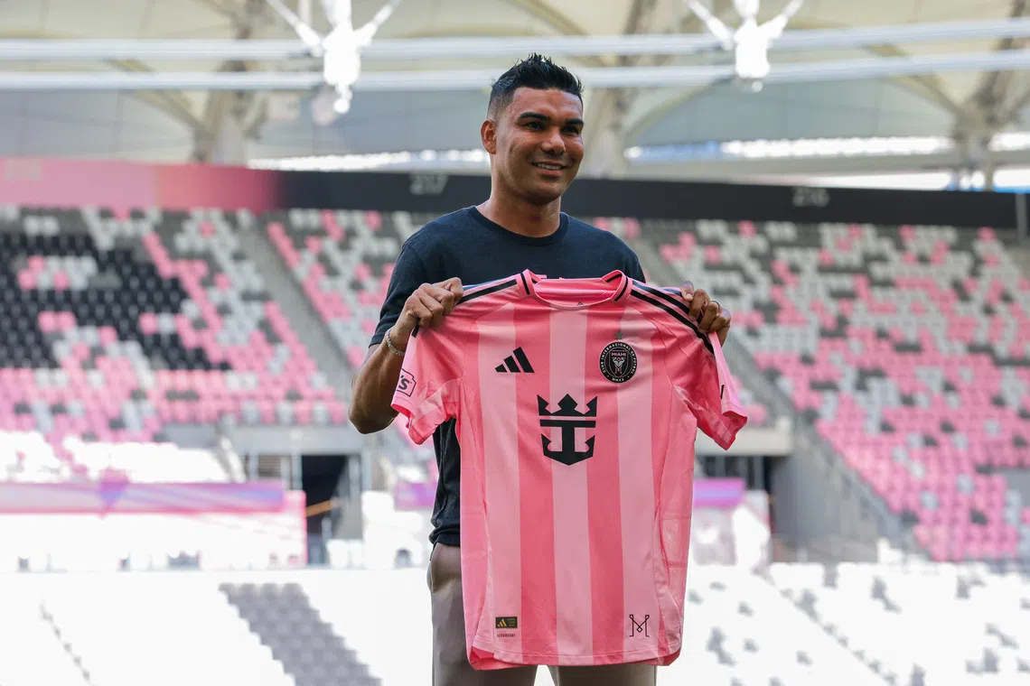Jul 30, 2026; Miami, FL, USA; Inter Miami CF midfielder Casemiro (5) poses with a jersey during his presentation as a new member of the team at Nu Stadium. Mandatory Credit: Sam Navarro-Imagn Images