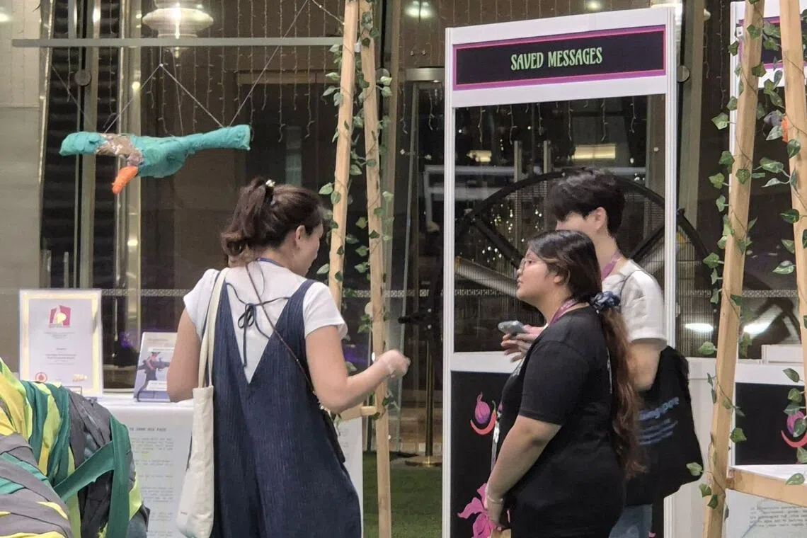 Sarah Sofian (centre) speaking to a Singapore Night Festival tour guide (left) and HeritageSG staff (right) during her job taster stint.