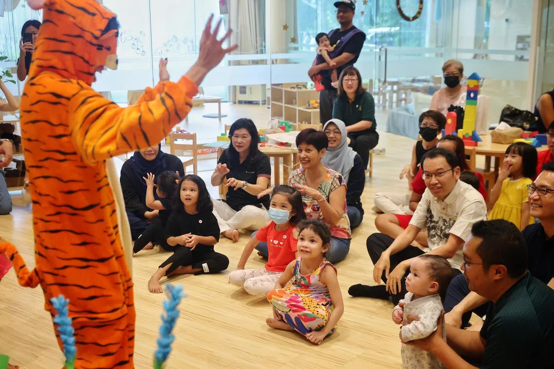 ST20231210_202392009122/juindranee10/Judith Tan/Jason Quah

Minister for Finance, and Second Minister for National Development Indranee Rajah sits with Kelsey Emmanualle Chen (red top, mask), five, and Nur Fareeha Raisha bte Md Yazid (right, colourful dress), five, during a storytelling session for children from low-income families, at the Gardens Learning Hub at Bayfront Plaza, Gardens by the Bay, on Dec 10, 2023.
//
Over 10,000 children and parents from low-income families to benefit from free nature-based educational activities under Gardens by the Bay's new Gardens Learning Fund.