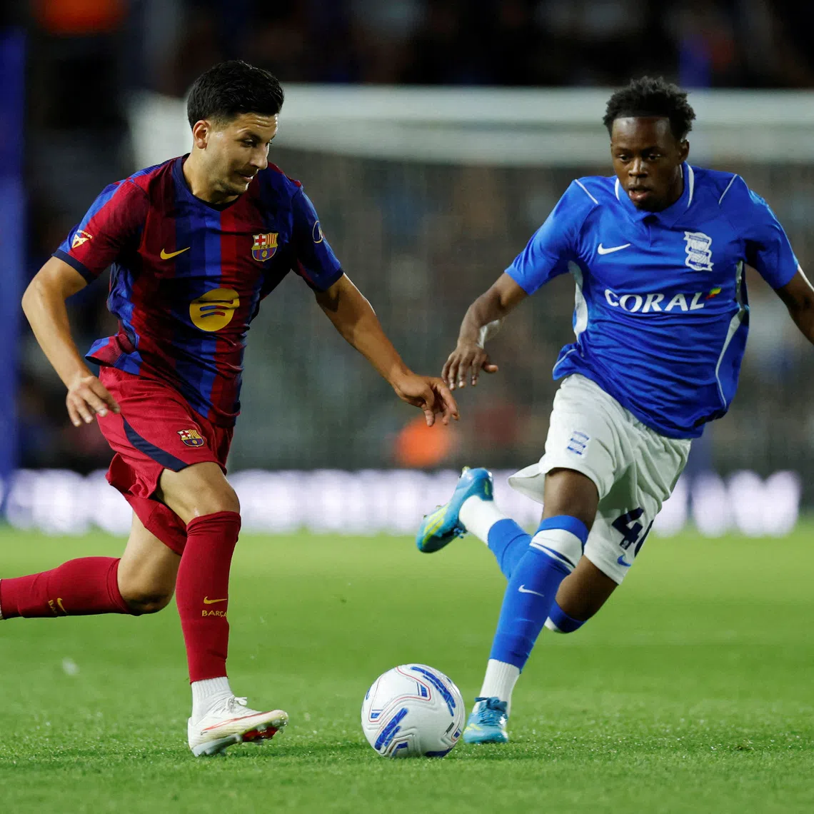 FILE PHOTO: Soccer Football - Pre Season Friendly - Birmingham City v FC Barcelona - St Andrew's @ Knighthead Park, Birmingham, Britain - July 31, 2026 FC Barcelona's Roony Bardghji in action with Birmingham City's Menzi Mazwi Action Images via Reuters/Jason Cairnduff/File Photo