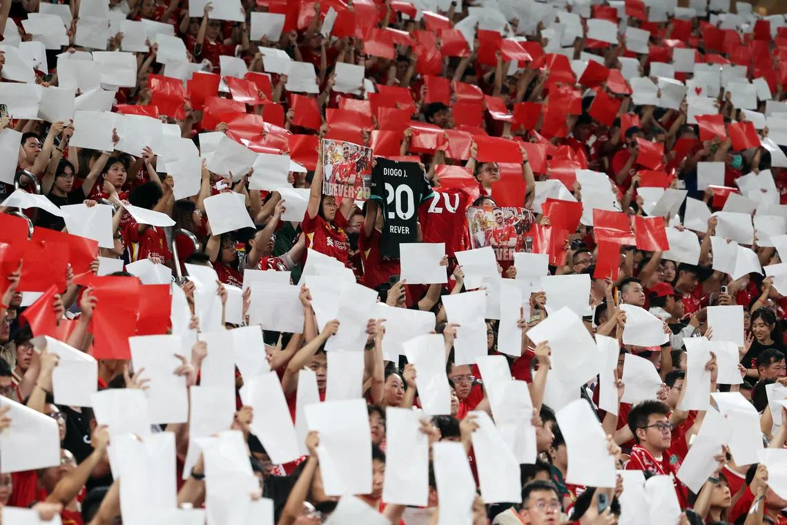 Soccer Football - Pre-Season Friendly - Liverpool v AC Milan - Kai Tak Sports Park, Hong Kong, China - July 26, 2025 Liverpool fans hold up shirts in memory of Diogo Jota inside the stadium before the match