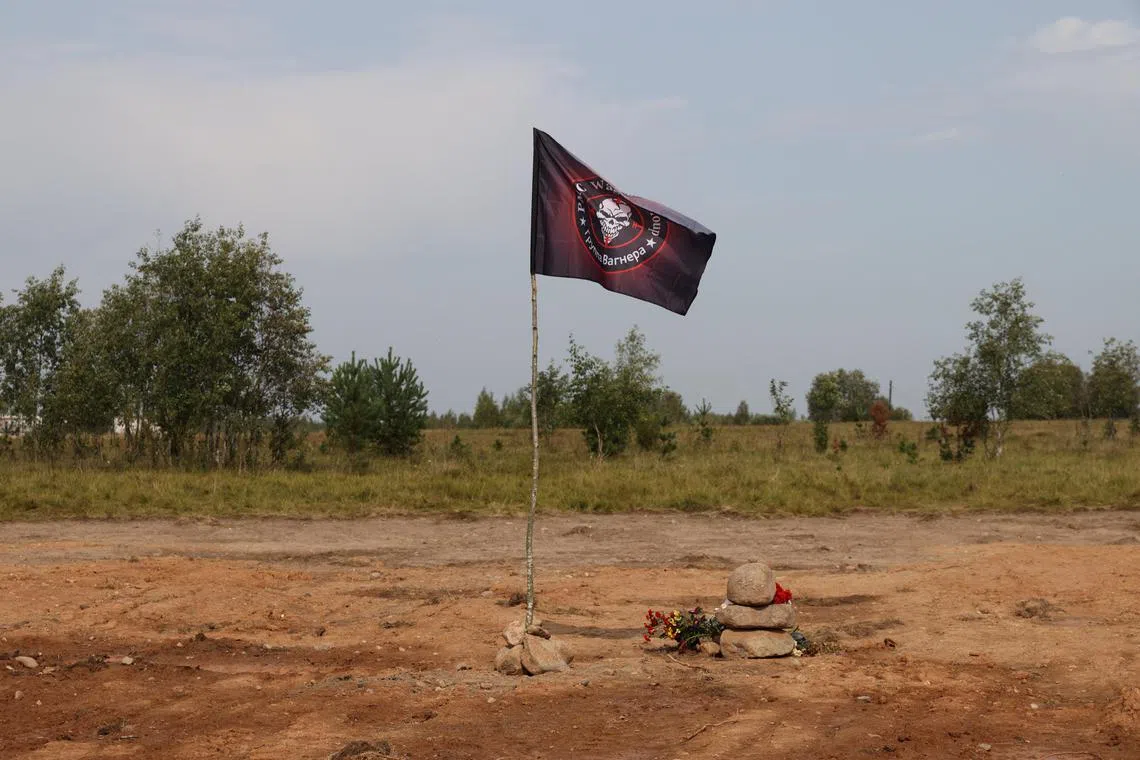 A Wagner flag makes up part of a makeshift stone memorial to the mercenary group's boss, Yevgeny Prigozhin.