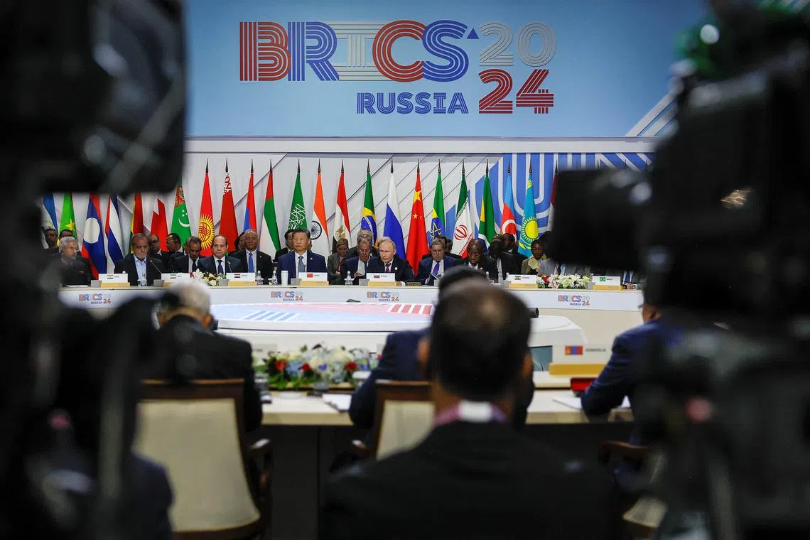 Officials, including Russian President Vladimir Putin, Chinese President Xi Jinping and Egyptian President Abdel Fattah al-Sisi, are seen through television cameras during a plenary session in the outreach/BRICS Plus format at the BRICS summit in Kazan, Russia October 24, 2024. REUTERS/Maxim Shemetov/Pool