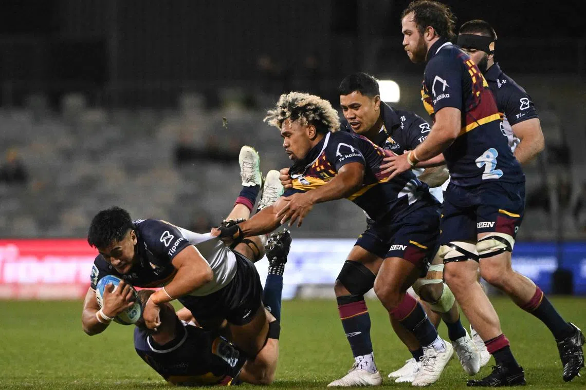 The ACT Brumbies' Tamati Tua is tackled in the Super Rugby Pacific quarter-final against the Otago Highlanders at Canberra Stadium on June 8, 2024.