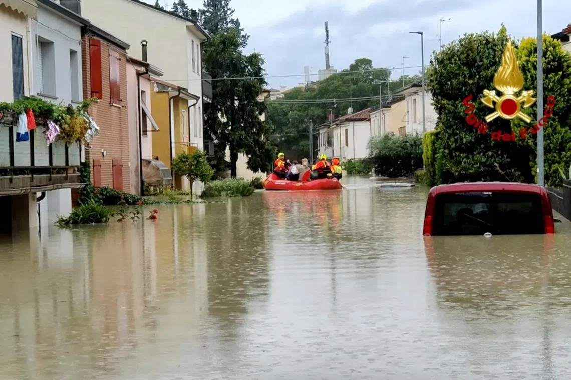 Rescuers taking people to safety in Forli, Italy, after floods hit the Emilia-Romagna region.