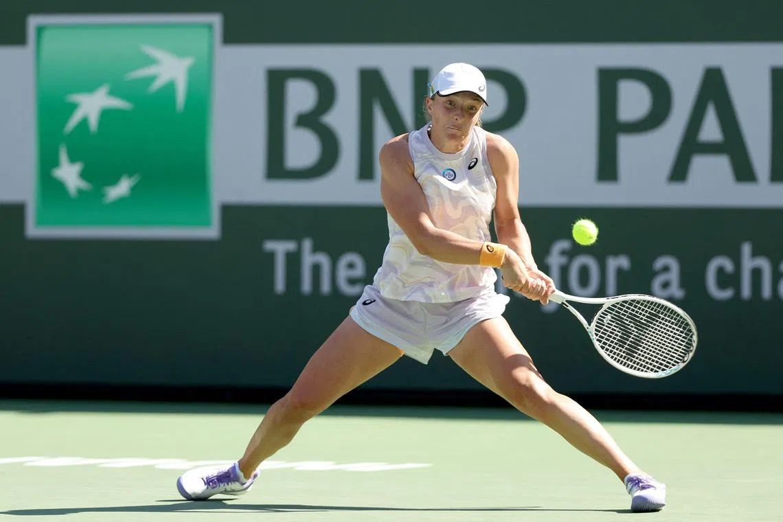 Iga Swiatek returns a shot to Sorana Cirstea en route to her 6-2, 6-3 win at Indian Wells.