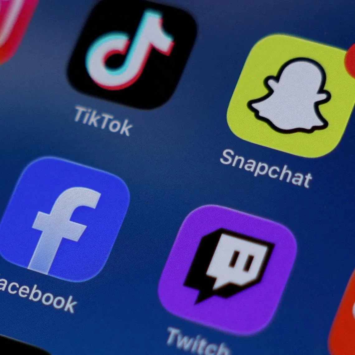 FILE PHOTO: Instagram, TikTok, Snapchat, YouTube, Facebook, Twitch and Reddit applications are displayed on a mobile phone ahead of new law banning social media for users under 16 in Australia, in this picture illustration taken on December 9, 2025. REUTERS/Hollie Adams/Illustration//File Photo