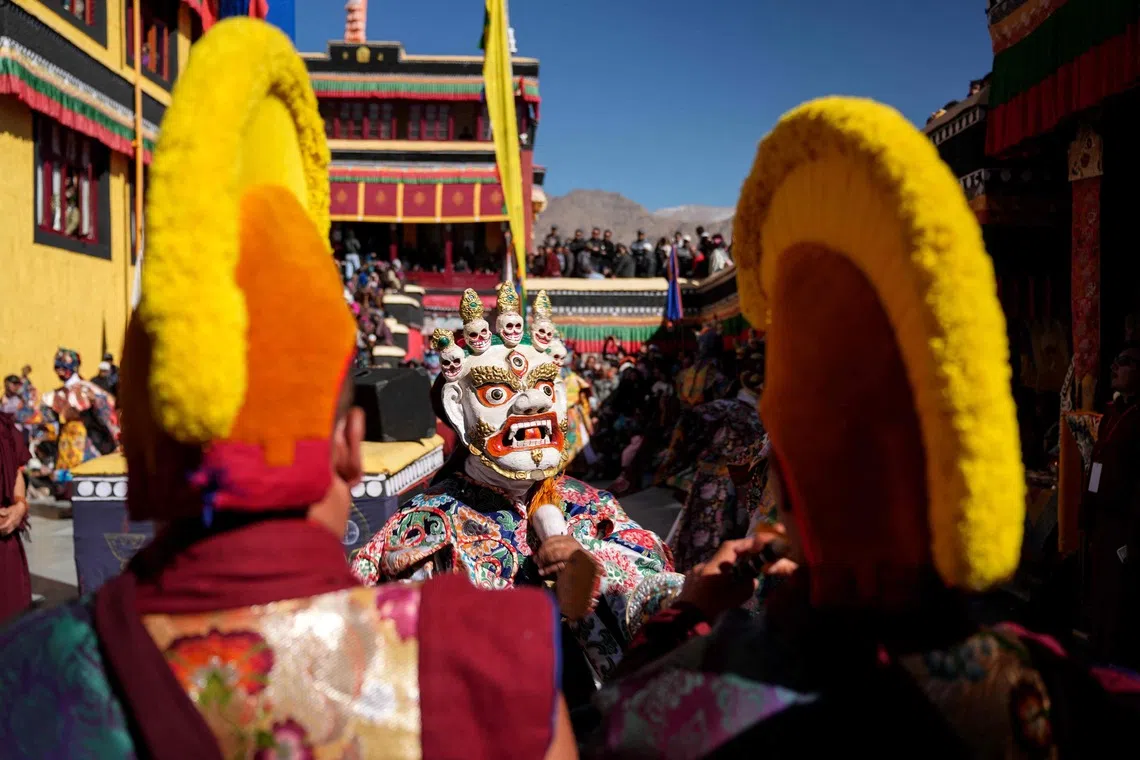 TOPSHOT - A Buddhist monk wearing a colourful silk robe and a deity mask performs during the Thiksey Gustor festival at the Thiksey monastery in India's Ladakh region on October 28, 2026. (Photo by Mohd Arhaan ARCHER / AFP)