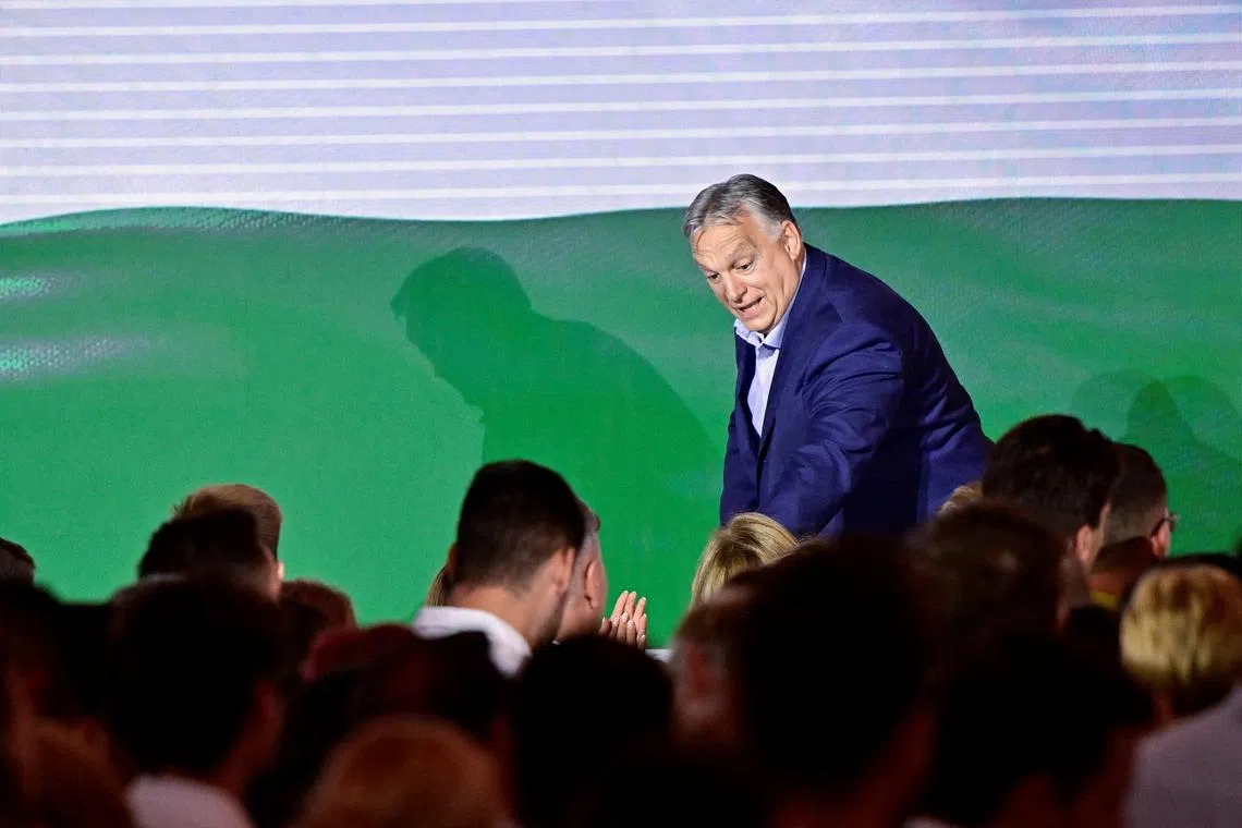 FILE PHOTO: Hungarian Prime Minister Viktor Orban greets people after the announcement of the partial results of the European Parliament and municipal elections, in Budapest, Hungary, June 10, 2024. REUTERS/Marton Monus/File Photo