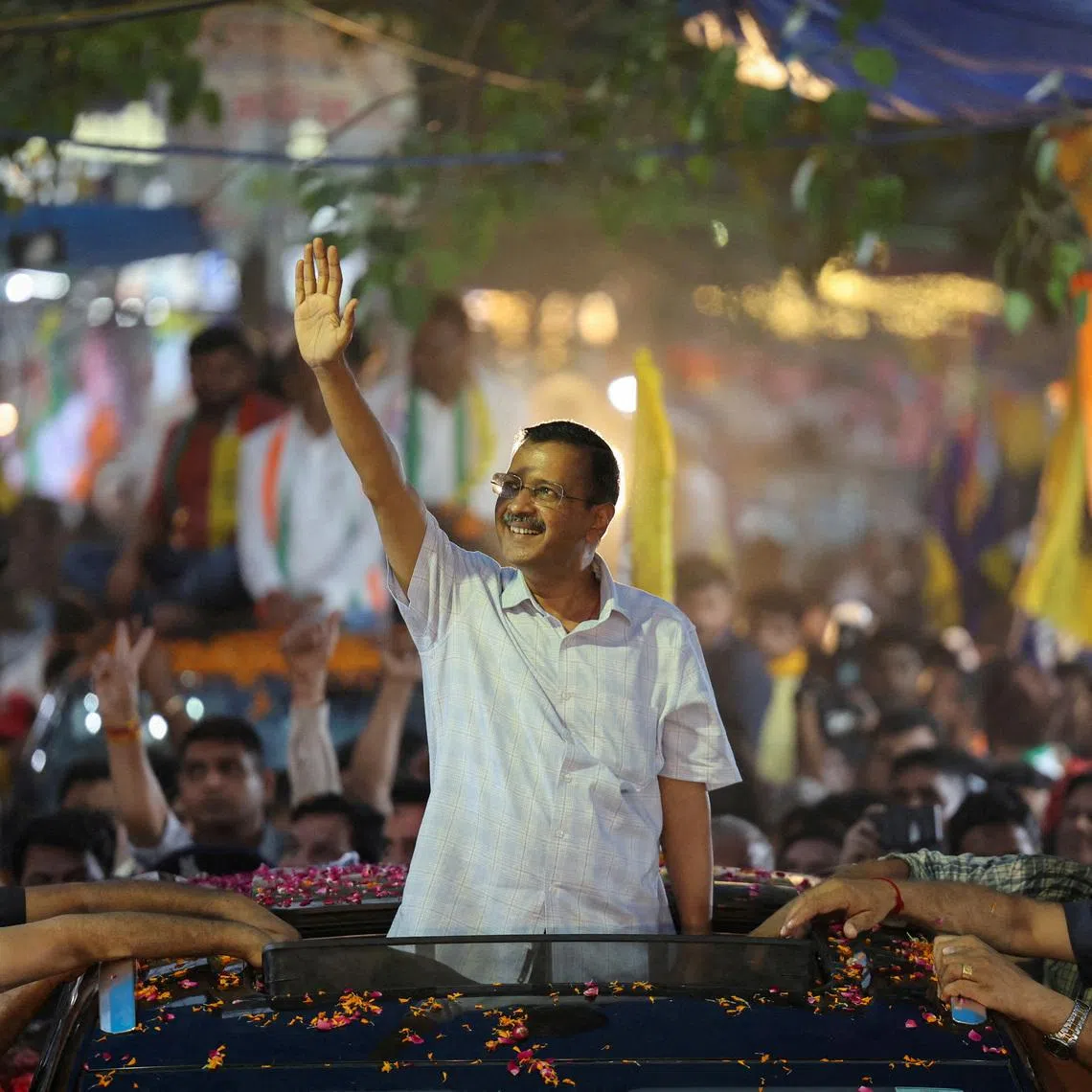 FILE PHOTO: People gather as Delhi's Chief Minister Arvind Kejriwal attends a roadshow after India's Supreme Court gave temporary bail to the Aam Aadmi Party's national convenor last week in a liquor policy case, in New Delhi, India, May 15, 2024. REUTERS/Anushree Fadnavis/File Photo