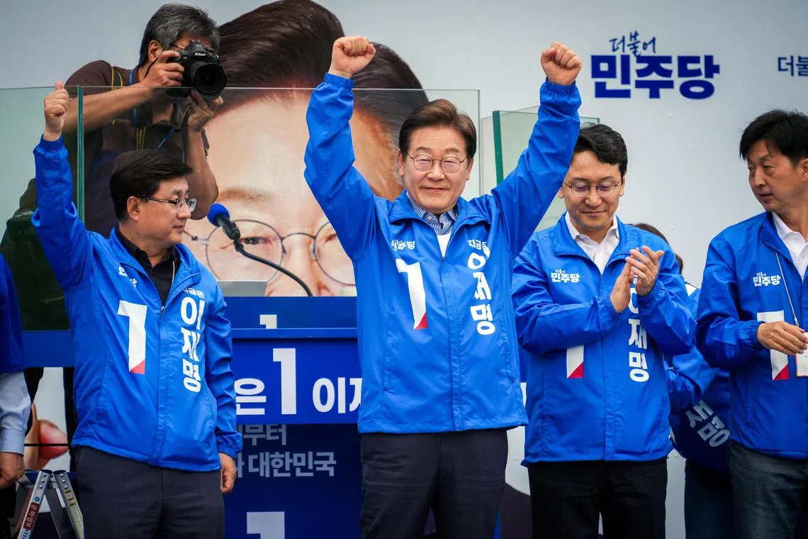 Lee Jae-myung, the Democratic Party candidate for president, raises his arms as he is appluaded at a campaign rally in Seoul on Monday, June 2, 2025. Lee, who is leading in polls, has said he would use his power to bring the country together and revive the economy.  (Jun Michael Park/The New York Times)