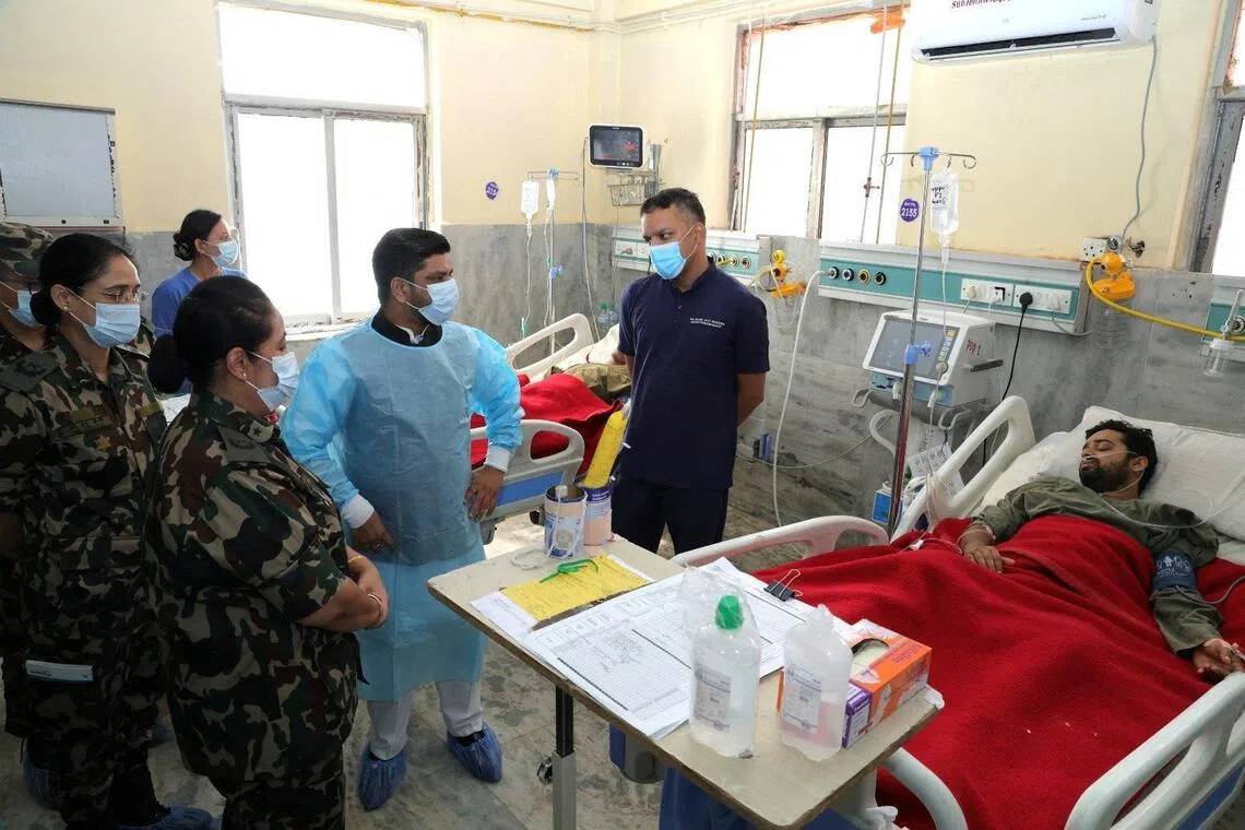 A survivor receives medical care after being rescued from a tunnel at the Trishuli 3A Hydropower Project.