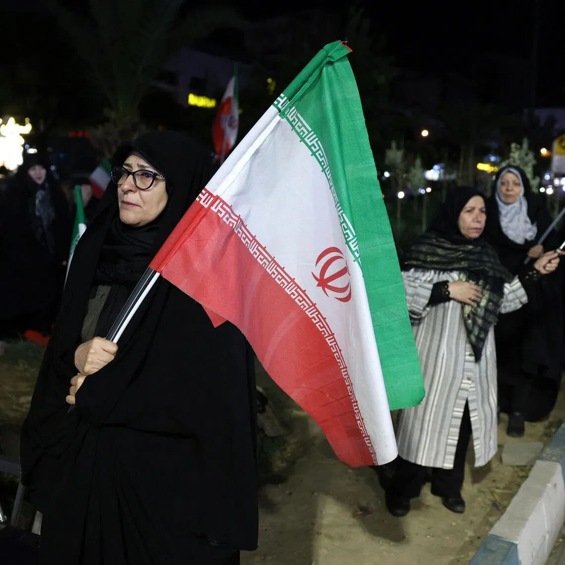 Women holding Iran's national flags during an anti-US and Israel protest in Tehran on May 17.