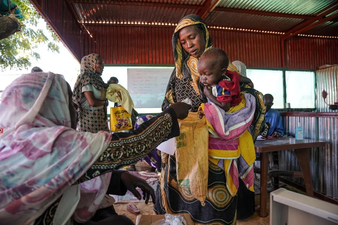 FILE PHOTO: A handout photograph, shot in January 2024, shows a woman and baby at the Zamzam displacement camp, close to El Fasher in North Darfur, Sudan. MSF/Mohamed Zakaria/Handout via REUTERS/File Photo