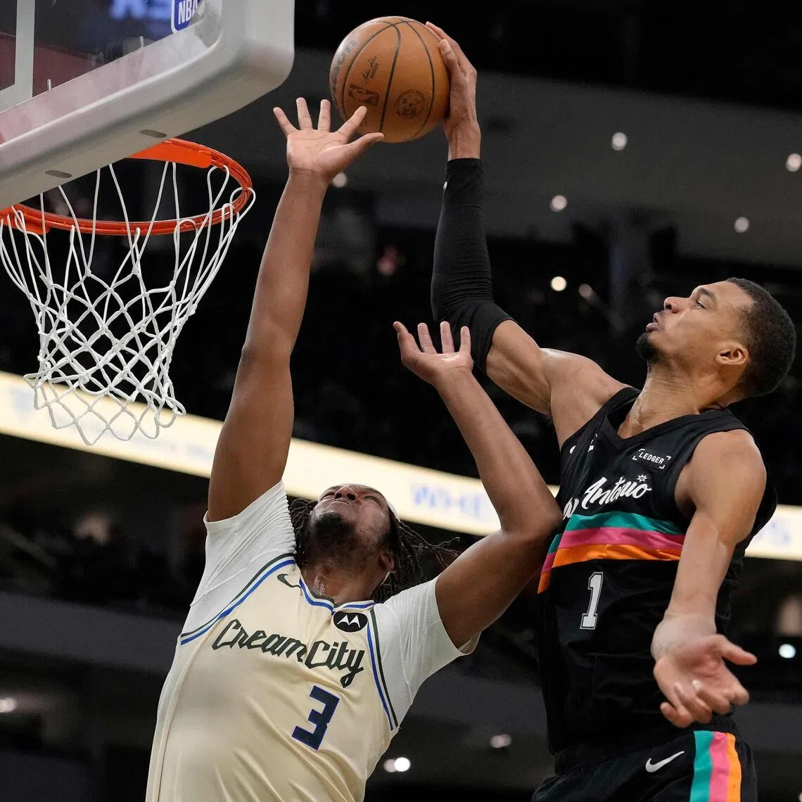 The San Antonio Spurs' Victor Wembanyama dunking over Myles Turner of the Milwaukee Bucks during the Spurs' 127-95 NBA win on March 28.