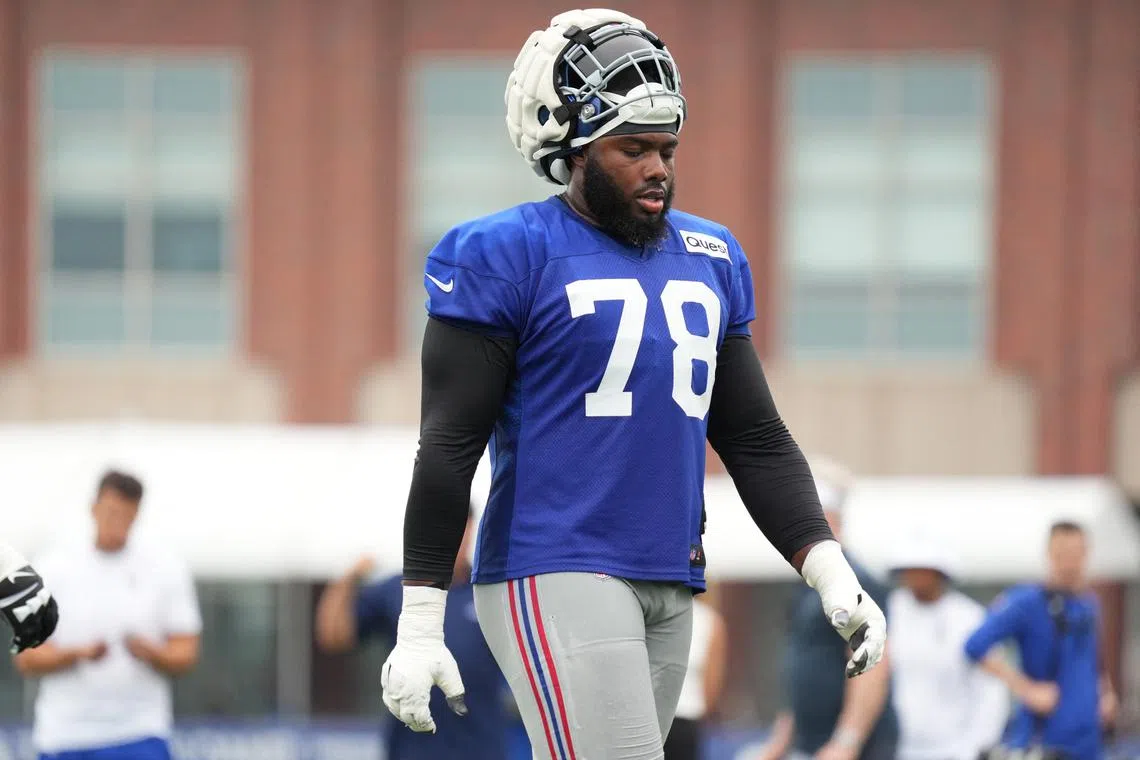 FILE PHOTO: Jul 25, 2024; East Rutherford, NY, USA; New York Giants offensive tackle Andrew Thomas (78) takes a water break during training camp at Quest Diagnostics Training Center. Mandatory Credit: Lucas Boland-USA TODAY Sports/File Photo