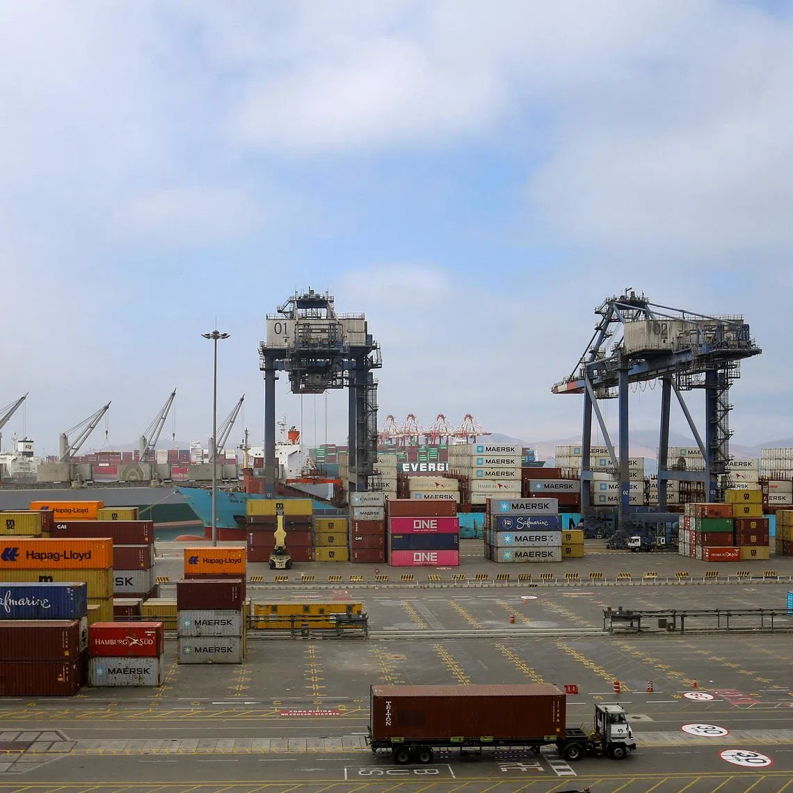 Workers handle containers at APM Terminals in the port of Callao, in Callao, Peru November 19, 2025. REUTERS/Gerardo Marin