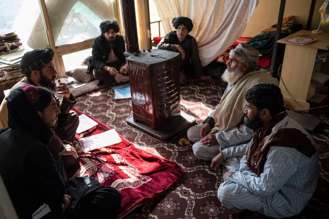 The head of the penal court, Mr Mohammad Mobin (second from left) listens to a man (second from right), who has been sentenced to death for murder, during a hearing at the Ghazni Court of Appeal in Ghazni, eastern Afghanistan.