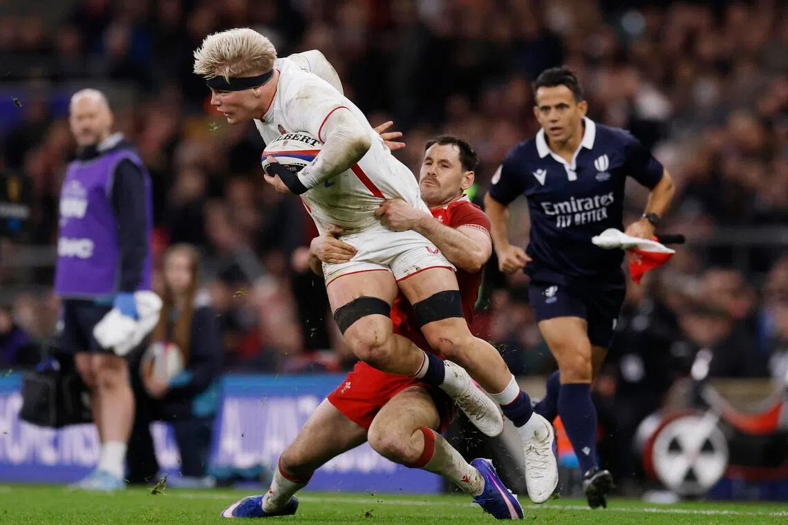 England's Henry Pollock being tackled by Wales' Tomos Williams during the 48-7 rout of Wales in the Six Nations on Feb 7, 2026 at Twickenham.