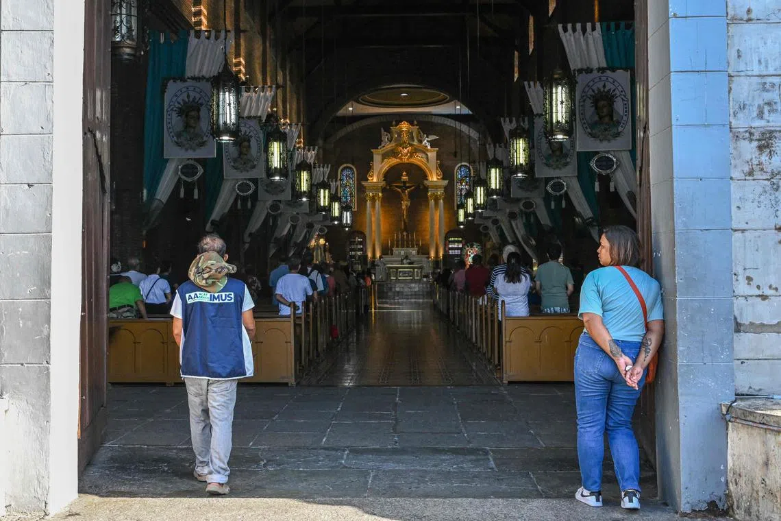 People attending a mass at the Imus Cathedral in Imus in the province of Cavite. Philippines.