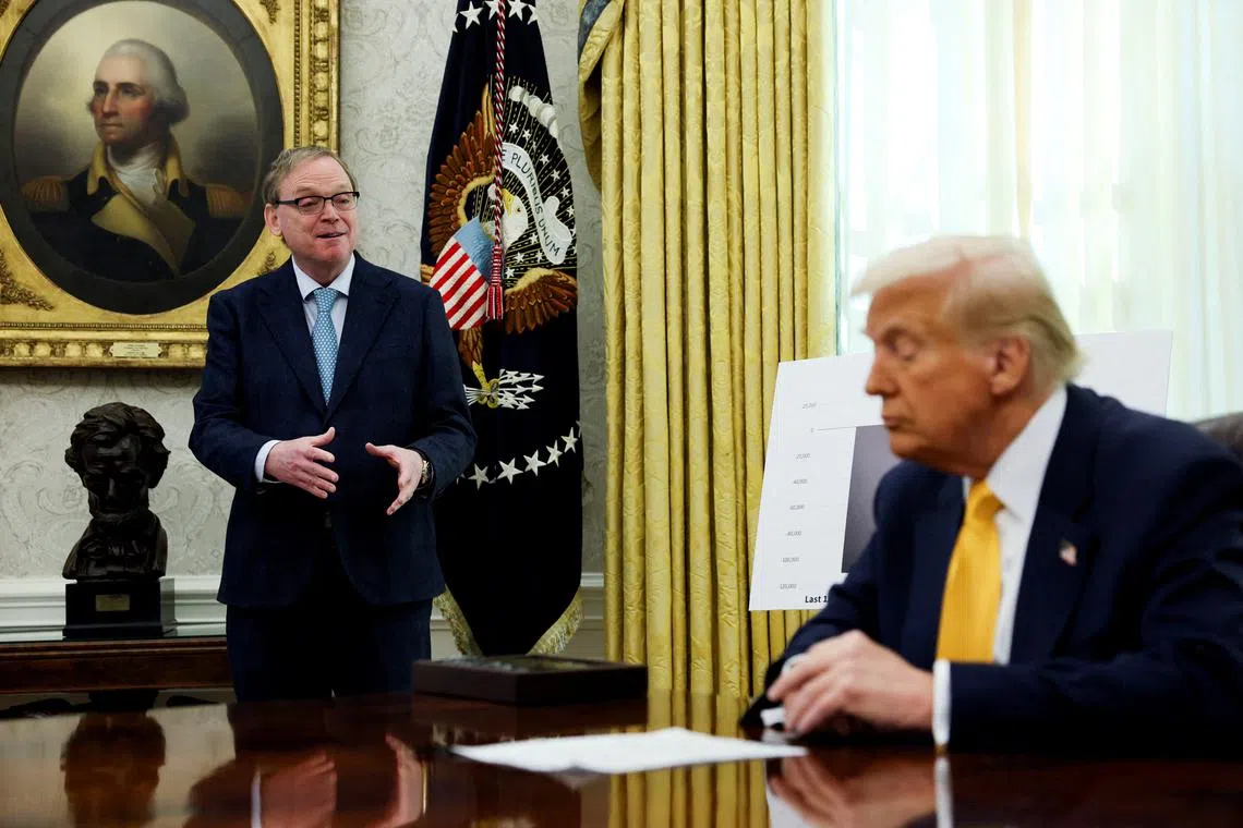 FILE PHOTO: White House economic adviser Kevin Hassett speaks next to U.S. President Donald Trump in the Oval Office of the White House in Washington, D.C., U.S., March 7, 2025. REUTERS/Leah Millis/File Photo