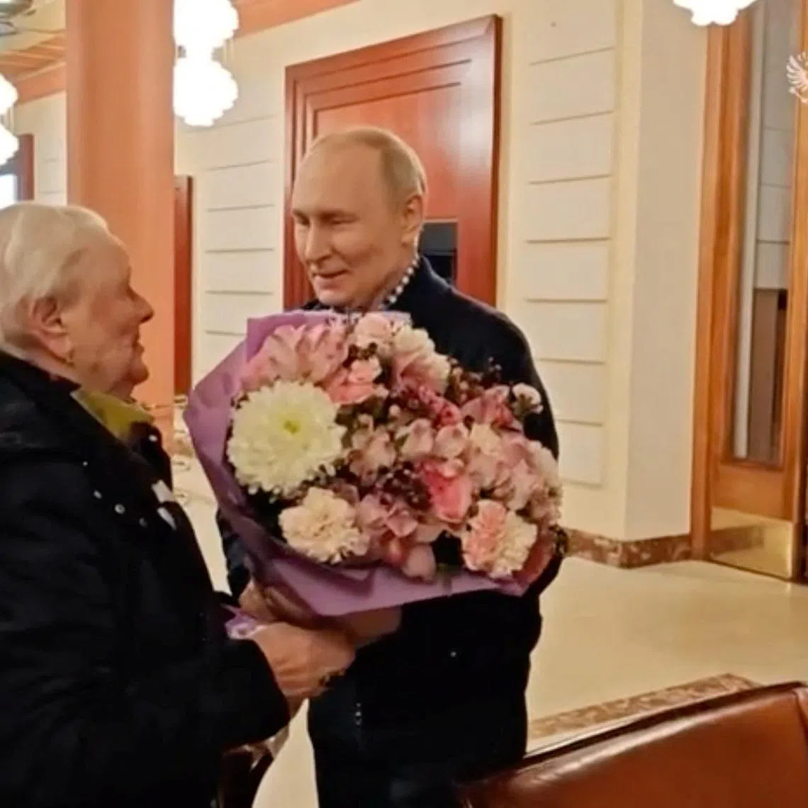 Russian President Vladimir Putin meets his former school teacher Vera Gurevich at a hotel in Moscow, Russia, in this still image from video released on May 11, 2026. Kremlin.ru/Handout via REUTERS