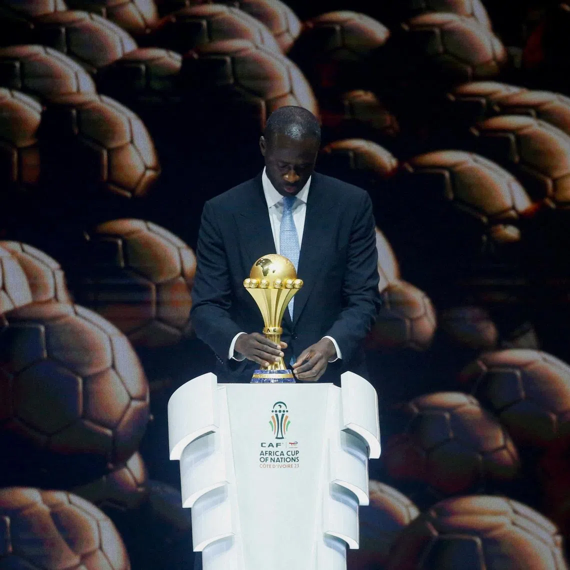 Soccer Football- Africa Cup of Nations draw.- The exhibition center of Abidjan, Ivory Coast - October 12, 2023. Yaya Toure holds the African Nations Cup during the draw. REUTERS/Luc Gnago