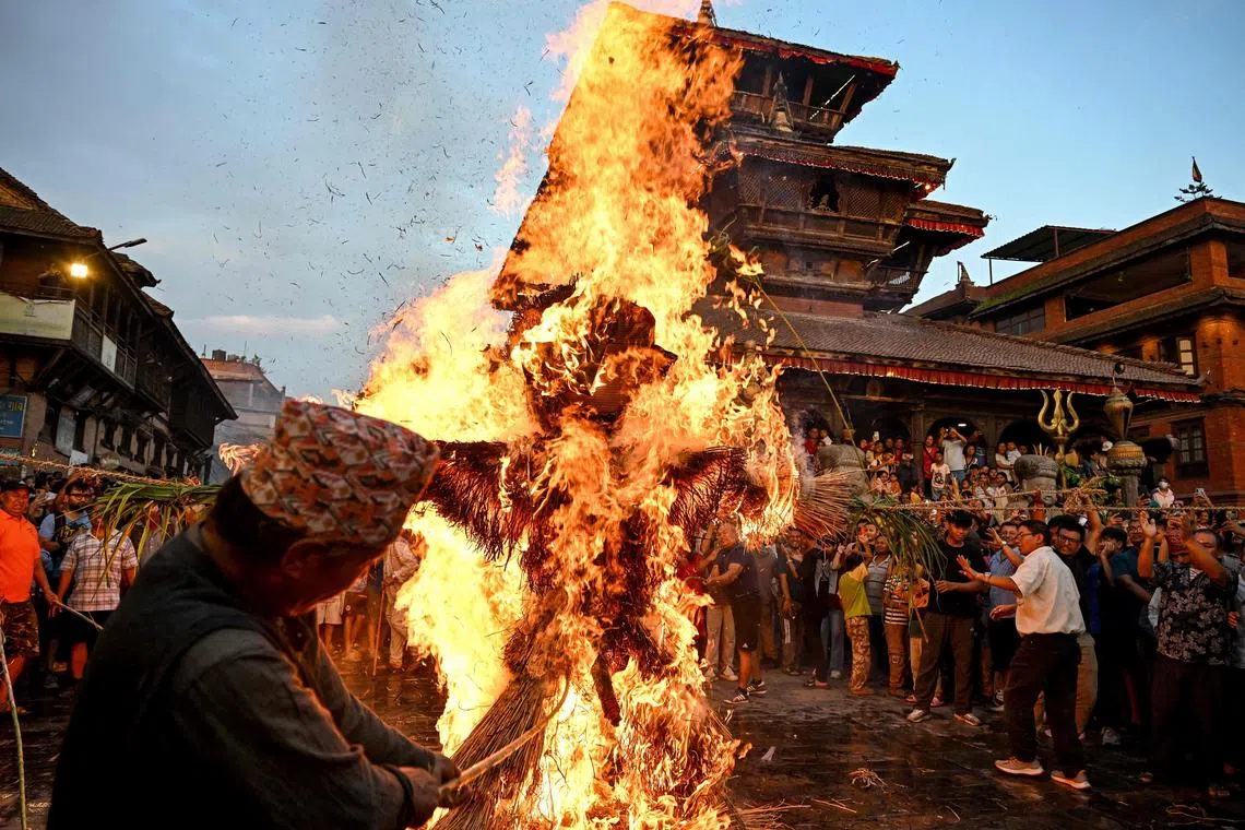 Hindu devotees burn an effigy of Ghanta Karna, a mythical demon, during celebrations to mark Gathemangal Festival in Bhaktapur on the outskirts of Kathmandu, Nepal, on July 23, 2025. 