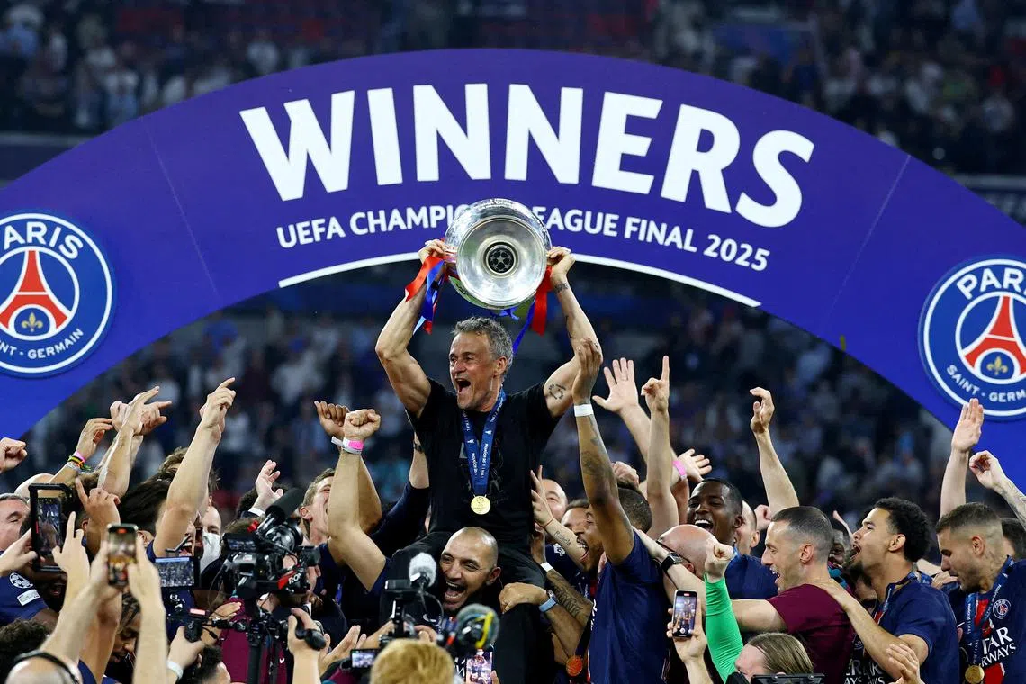 FILE PHOTO: Soccer Football - Champions League - Final - Paris St Germain v Inter Milan - Allianz Arena, Munich, Germany - May 31, 2025 Paris St Germain coach Luis Enrique lifts the trophy as he celebrates with his players after winning the Champions League REUTERS/Kai Pfaffenbach/File Photo