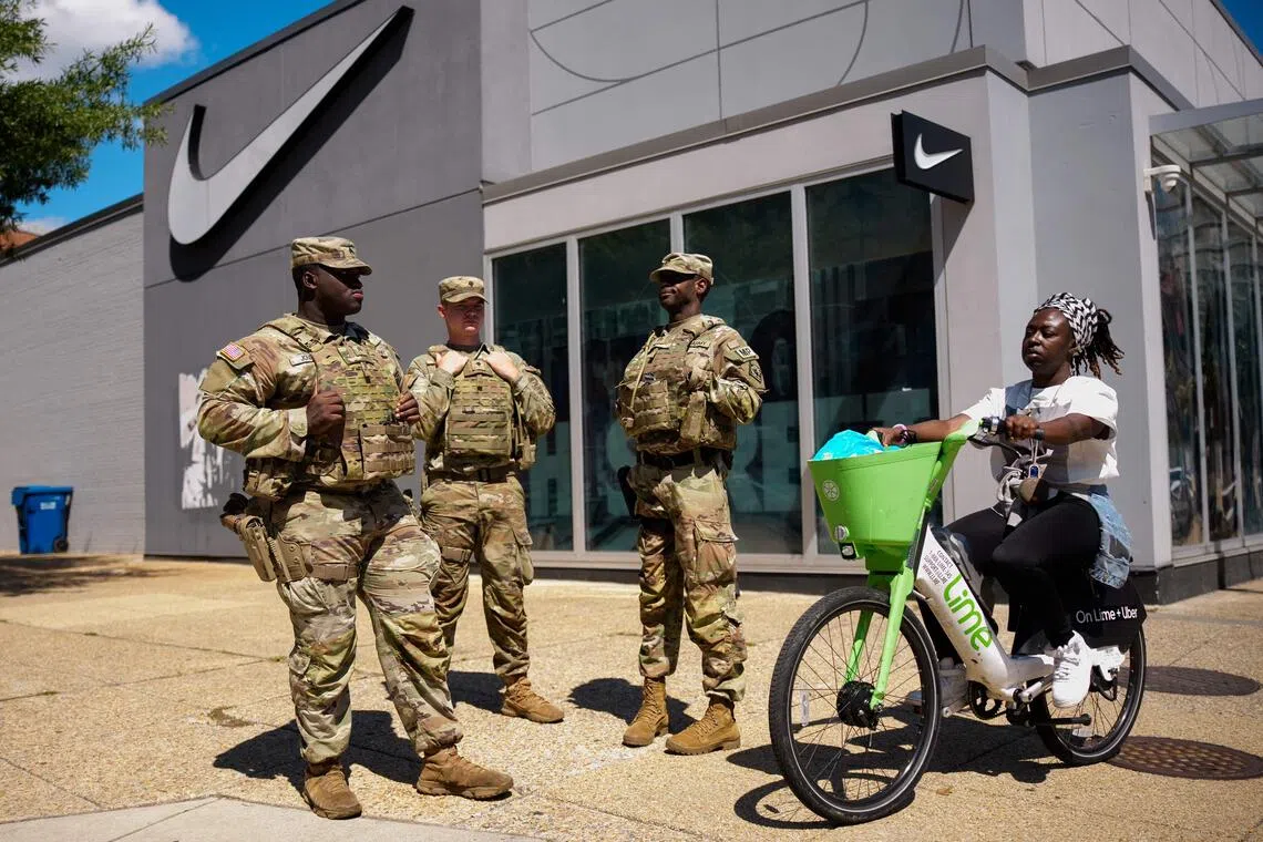 Armed members of the National Guard patrol in Washington after US President Donald Trump deployed them there to crack down on crime. The troops however have been relegated to other tasks, including cleaning up the streets.