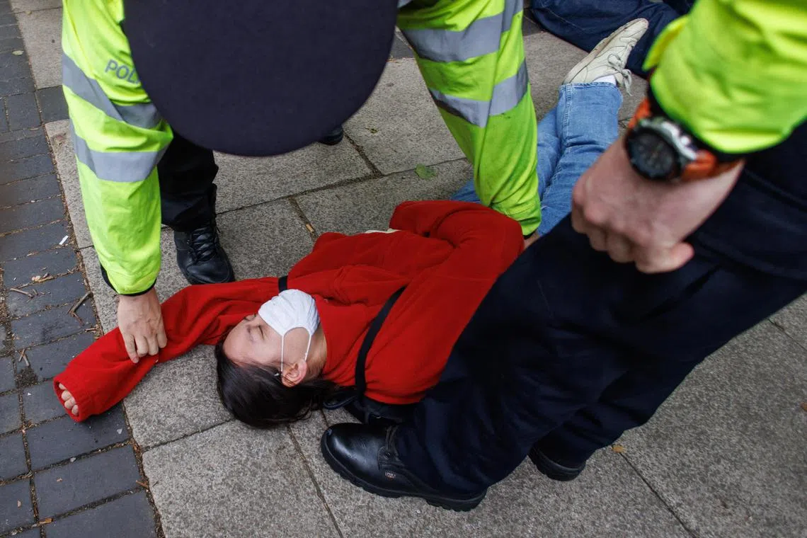Police officers started making arrests after protesters formed a blockade around a coach which was due to remove asylum seekers from a hotel in London to a specially built barge off southern England.