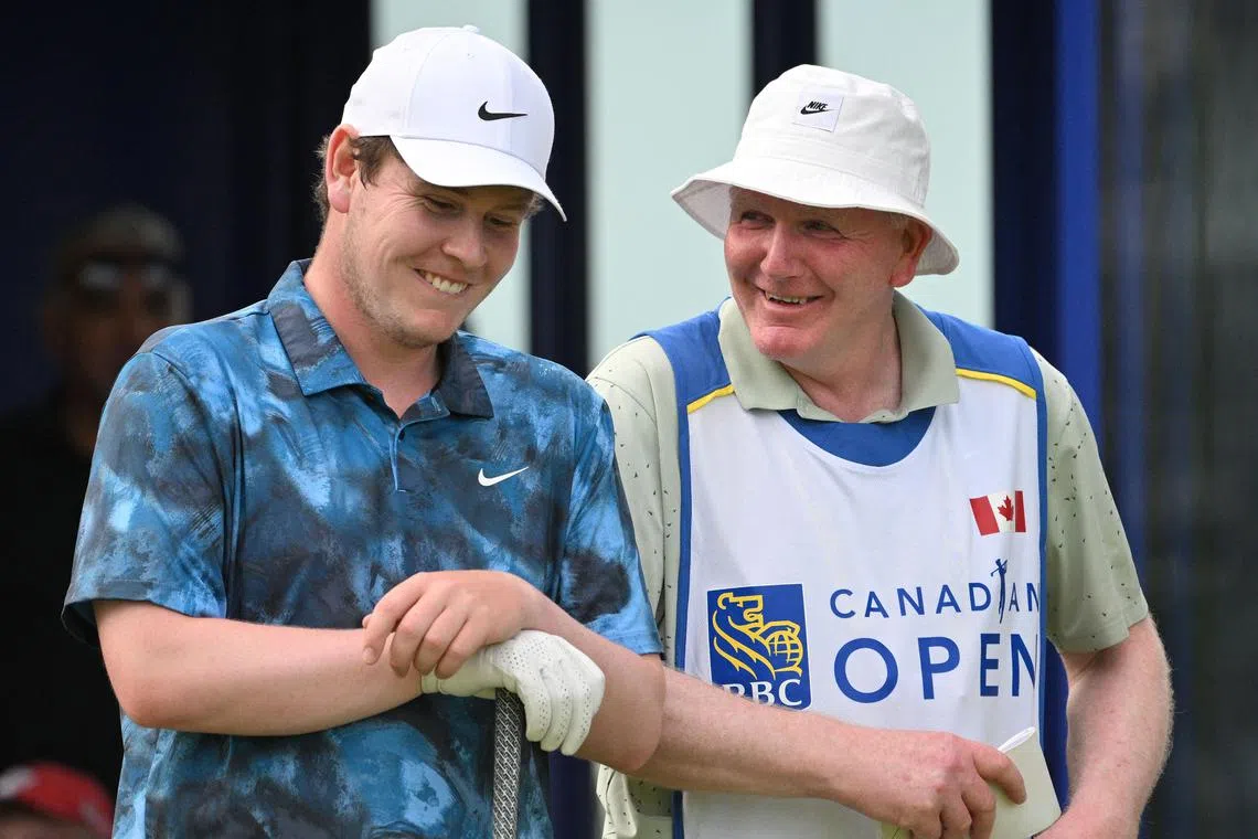 Leader Robert MacIntyre and his father Dougie, who is caddying for him, sharing a light moment on the 17th tee, during the third round of the Canadian Open golf tournament on June 1.