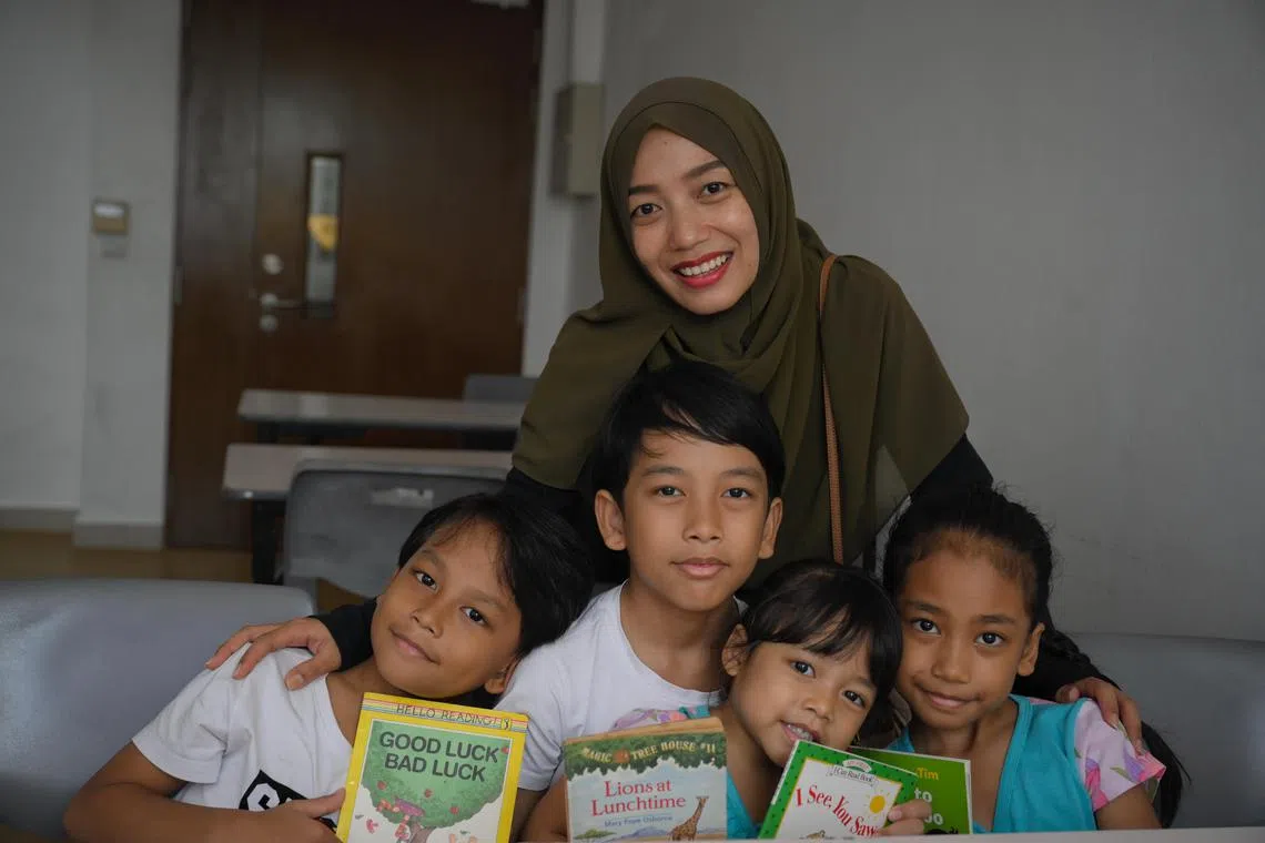 Ms Febri Wulandari, 39, and her children – (from left) Fachrul Fikriansyah, seven; Yusuf Fachri Fikriansyah, 10;  Farsha Fardilah, four; and Farah Faizia Hazanul Bidhri, nine – all of whom are involved in the Reading Roots reading programme held at MacPherson Community Club.