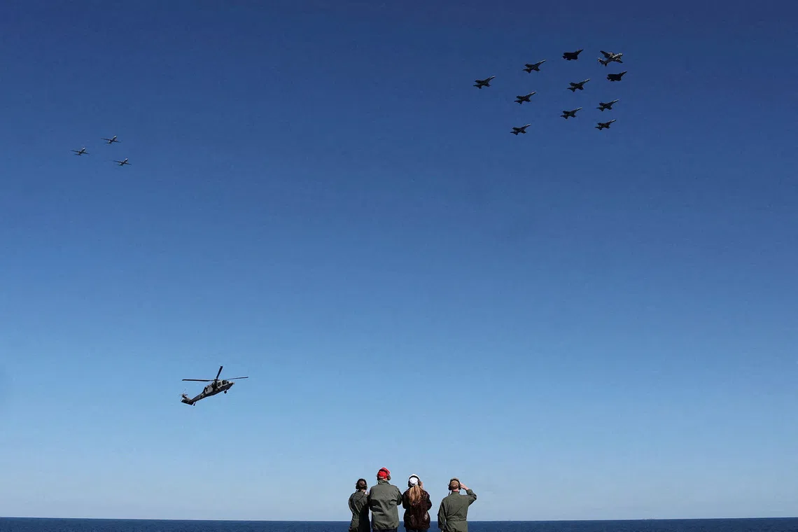 U.S. President Donald Trump and first lady Melania Trump observing aircraft aboard the aircraft carrier USS George H.W. Bush, off the coast of Norfolk, Virginia, U.S., on Oct 5, 2025. 