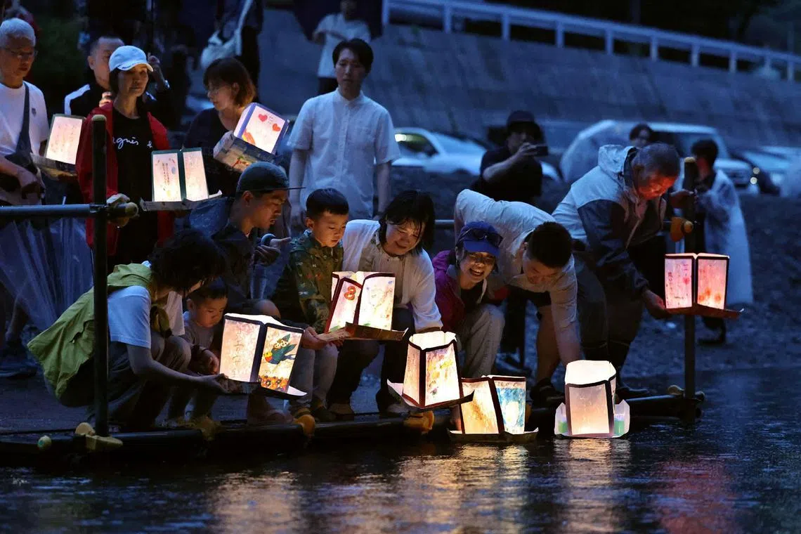 Bereaved families and friends release lanterns for those who died 40 years ago when a Boeing 747 flight from Tokyo to Osaka crashed into a mountain.