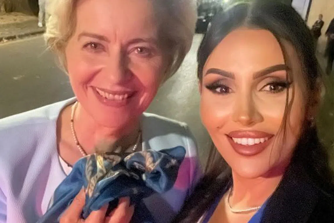 Sumaya Abdelbi, a tourist guide in La Alhambra palace, poses in a selfie with European Commission President Ursula von der Leyen as she holds a scarf that Abdelbi gave to von Der Leyen in Granada, Spain, in this picture taken October 5, 2023. Sumaya Abdelbi/Handout via REUTERS
