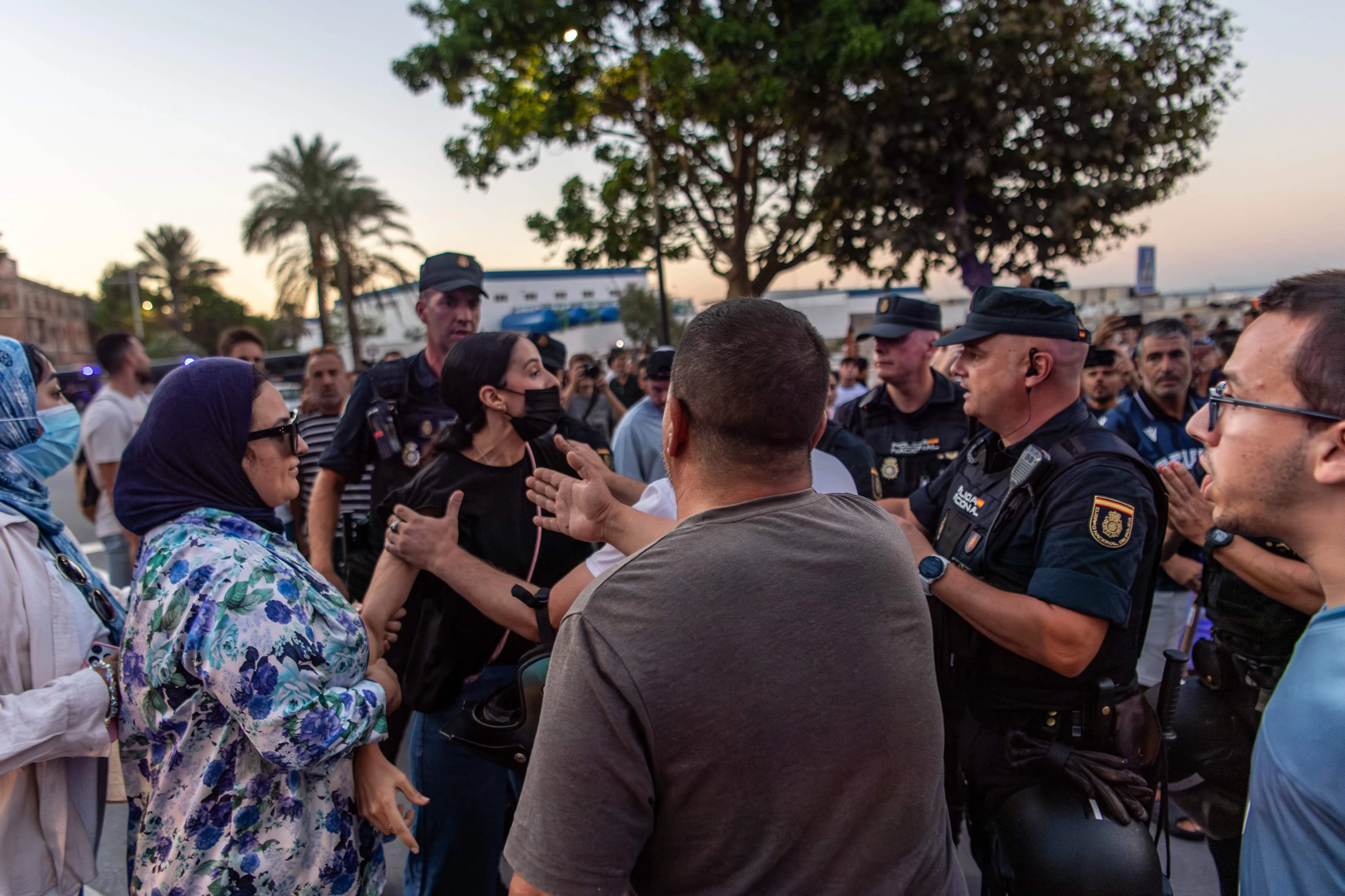 Residents arguing with police on Aug 28, near a demonstration against the presence of migrants in Spain’s north African enclave of Ceuta.