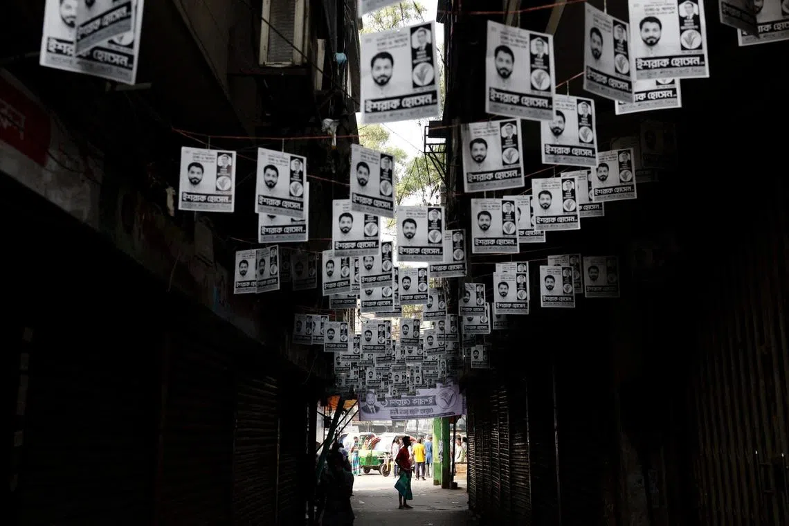 Election campaign posters bring hung over a street a day ahead of the national election in Dhaka, Bangladesh on  Feb 11, 2026. 