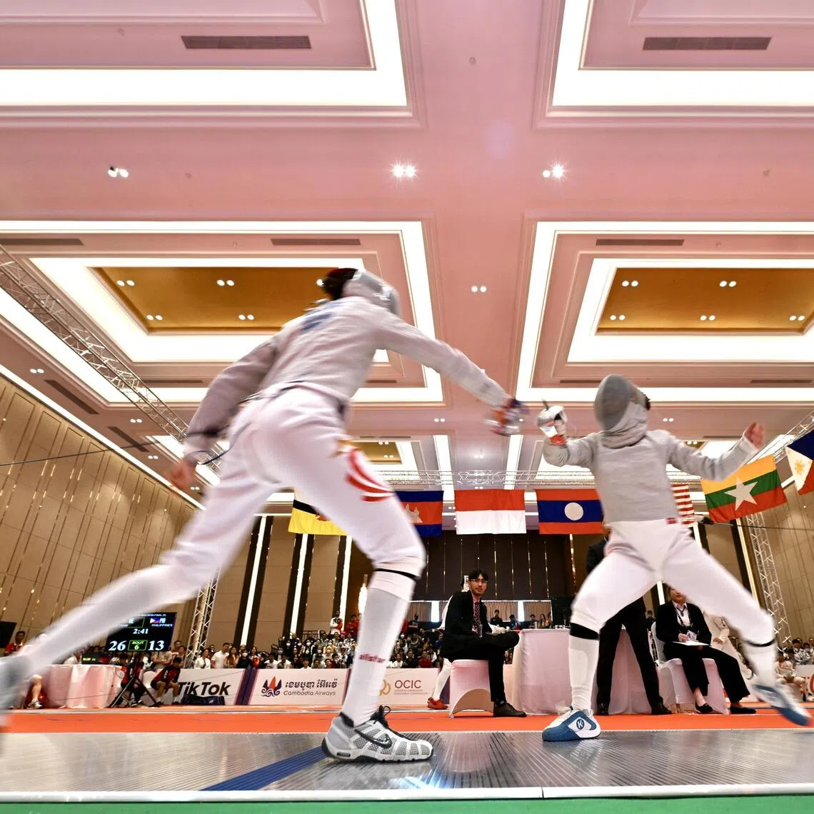 Singapore’s Juliet Heng( left) will be looking to retain her women's sabre crown as the fencing competition gets underway at the SEA Games.