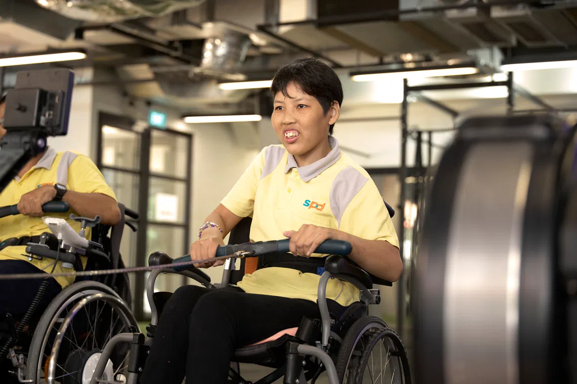 Regular exercise sessions organised by the SPD Day Activity Centre help Ms Veronica Tan work on her physical mobility. 